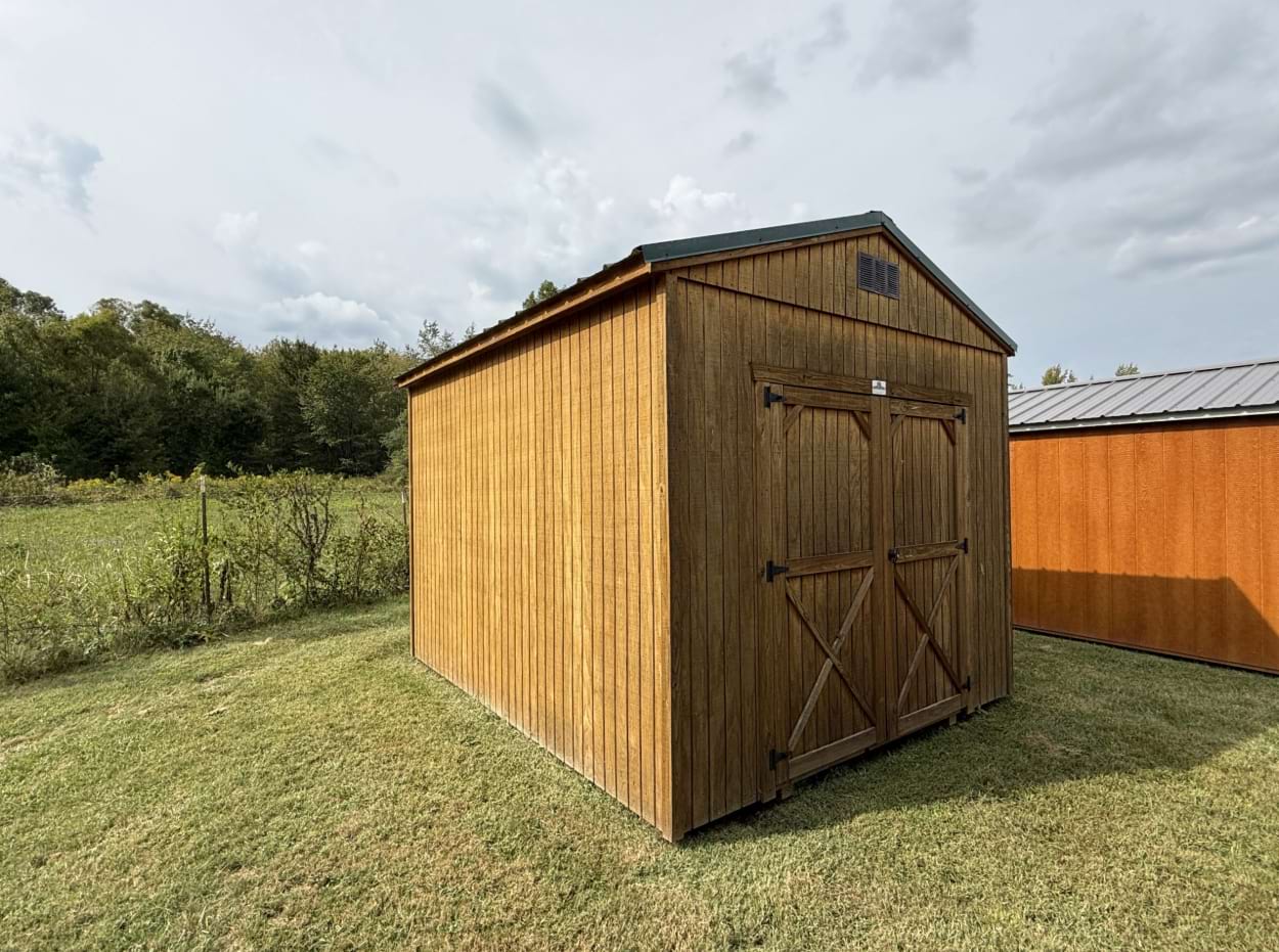 Utility shed with honey gold walls and a hunter green roof