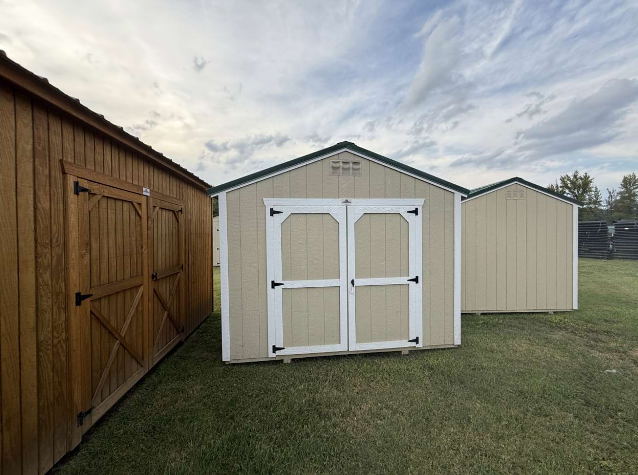 ten by ten utility shed outside view with cream siding white trim and a black roof