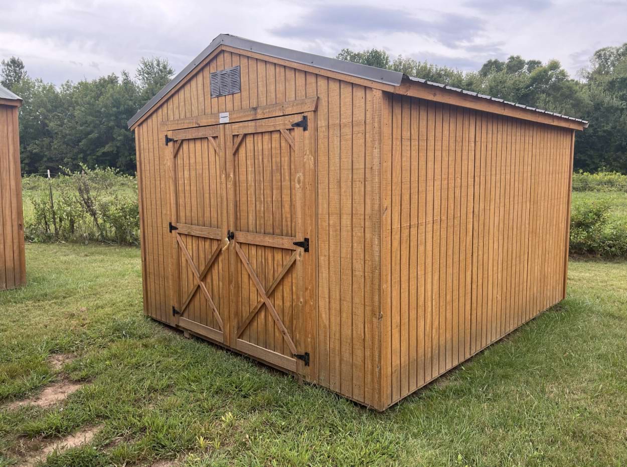 ten by twelve utility shed that is twenty percent off outside shot with a golden brown wooden siding