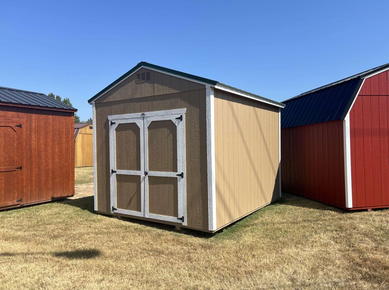 ten by twelve utility shed outside with buckskin colored siding