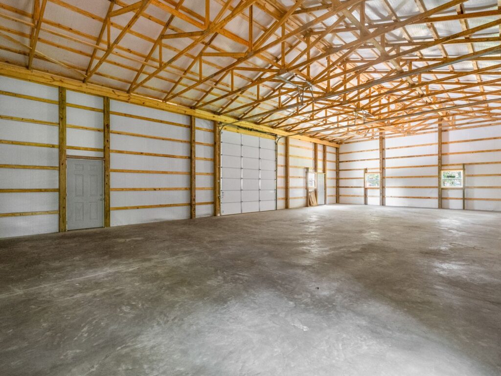 Inside a finished pole barn: posts, trusses, girts and steel