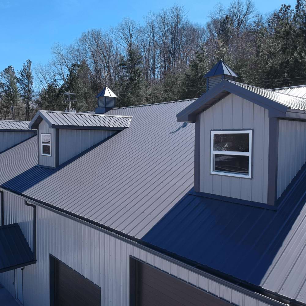 White Single Hung Vinyl Windows on a gray house with cupolas