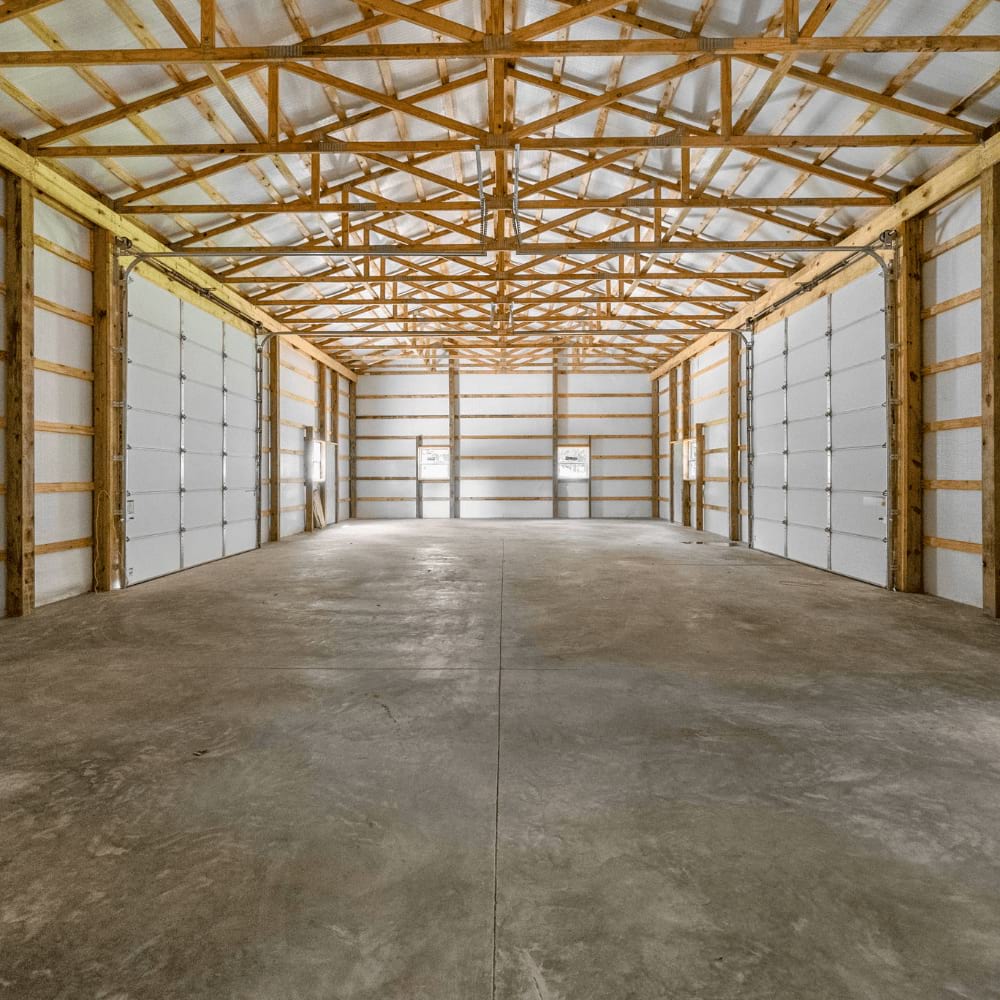 Standard flat trusses inside a garage with two overhead doors on each side