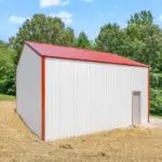 Custom-built white metal pole barn garage with red trim and dual overhead doors, measuring thirty by thirty feet with twelve-foot walls, constructed on a four-inch concrete pad—perfect for post frame buildings, residential storage, workshops, or vehicle parking.