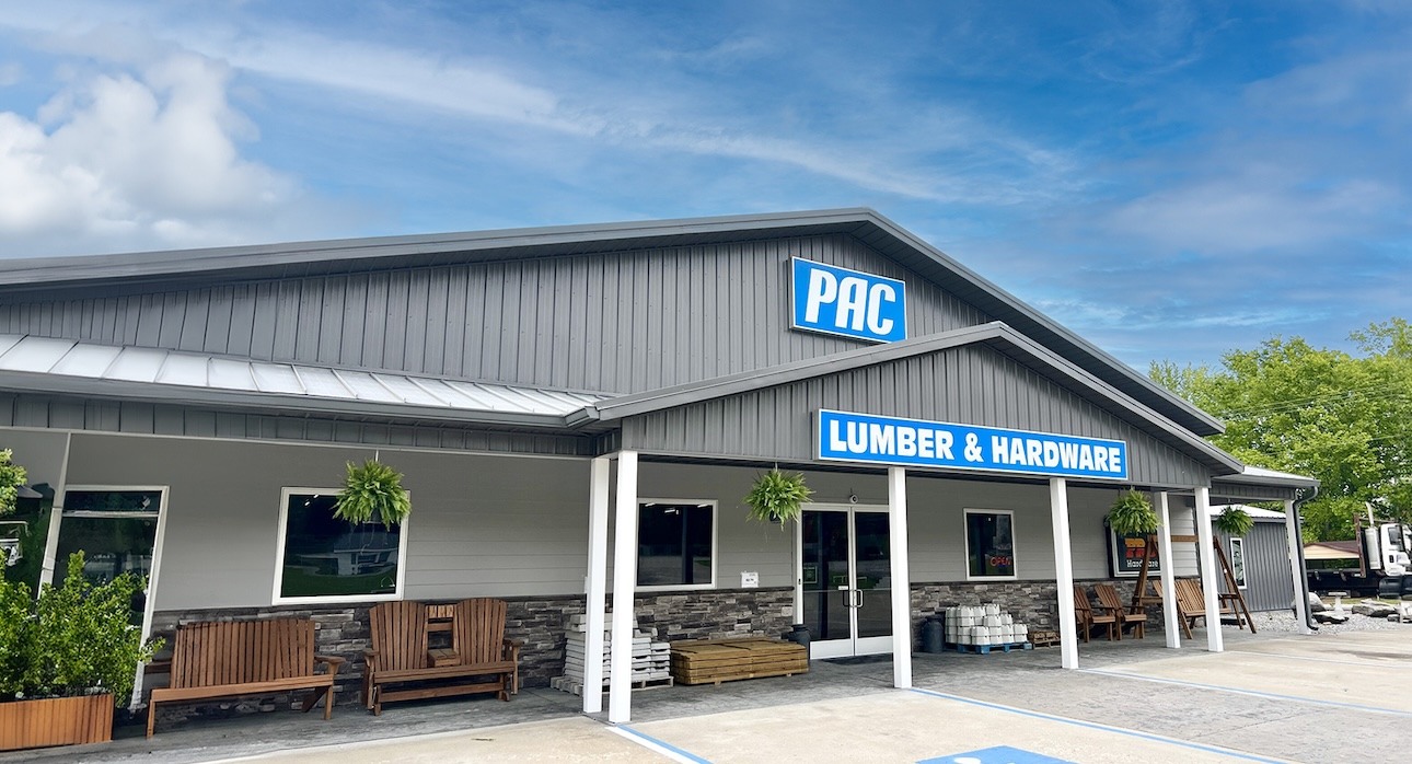 outside shot of the waverly tn PAC lumber and hardware store front, with wooden handmade benched and chairs out front