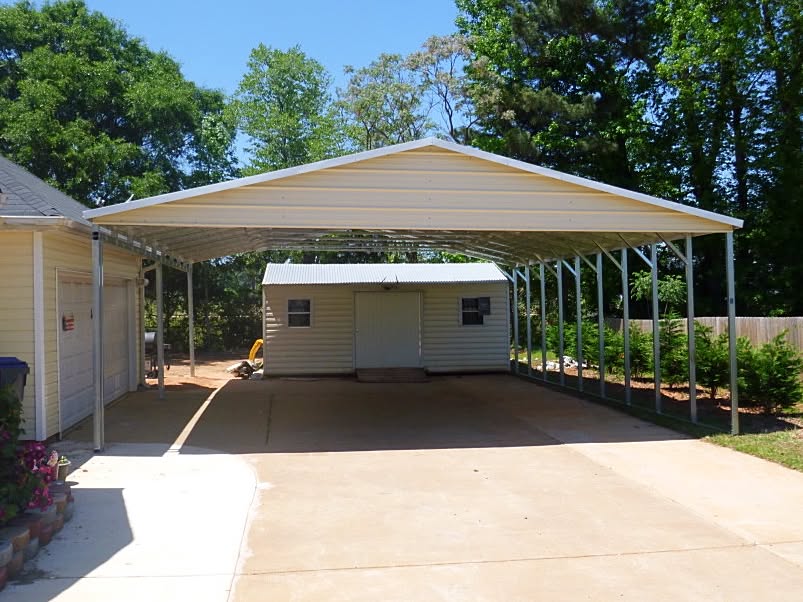 Steel garage with side carport